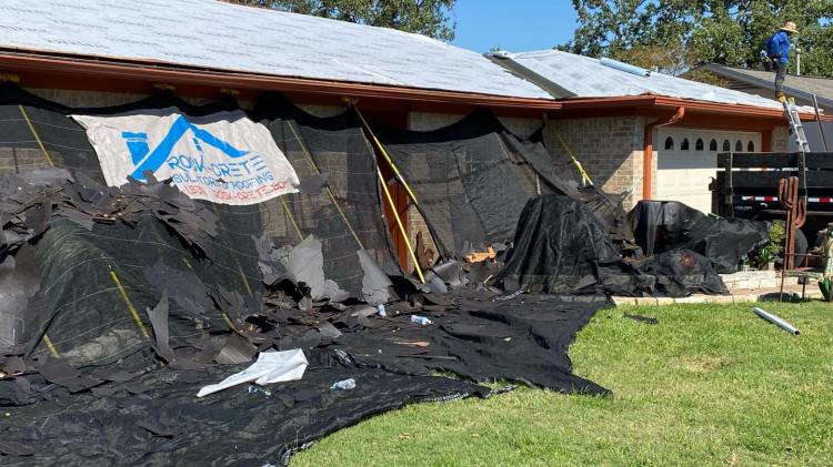 House with catch all system up and debris on the ground